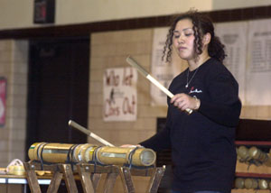 A member of the Bamboo Orchestra of Japan plays a drum made of bamboo during a performance for Coldwater students on Wednesday. The group has more than 20 instruments made of bamboo and will be holding a public concert Saturday at Arts Place in Portland, Ind. See story on page 7A.<br>dailystandard.com
