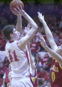 St. Henry's Kurt Huelsman, left, shoots over a New Bremen defender during their game on Monday night at Redskin Gymnasium. Huelsman scored 11 points, pulled down a game-high 12 rebounds and added seven blocks to help the Redskins to a 54-37 win over the Cardinals in a Midwest Athletic Conference matchup.<br>dailystandard.com