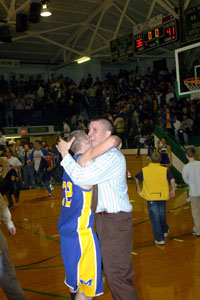 St. Marys head coach Josh Leslie, right, hugs senior Wes Clark, 32, after the Roughriders won the Western Buckeye League title outright on Friday night at the Celina Fieldhouse.<br>dailystandard.com