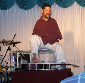 Tony Melendez, a Christian musician and composer born without arms, plays guitar before a crowded audience in St. Henry on Wednesday night. Melendez has performed across the United States and in 27 foreign countries including several visits to the Vatican.<br>dailystandard.com