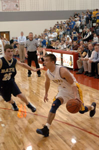 St. Marys' Corey Vossler tries to drive past Bath's Justin Rex during Wednesday's Division II sectional game at Lima Senior. Vossler led all scorers with 14 points to lead St. Marys to a 49-33 victory over Bath.<br>dailystandard.com