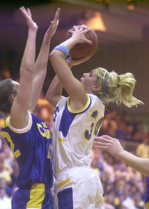 Marion Local's Kelsey Schaefer, 34, tries to shoot over Xenia Christian's Moriah Frazee, left, during their regional final contest on Saturday at Vandalia-Butler High School. Xenia Christian defeated Marion Local, 53-48.<br>dailystandard.com