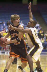 Minster's Jake Luttmer, 12, tries to find an open teammate as St. Bernard-Elmwood Place's Quincy Curry applies the defense.<br>dailystandard.com