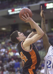 Minster's Andy Beckman tries to put up a shot over the outstretched arm of a Lutheran East defender. The season for the Wildcats ended Thursday evening on a last-second shot in the second overtime to give Lutheran East the 86-84 victory in the Division IV state semifinals at the Schottenstein Center on the campus of The Ohio State University. Minster ends the season at 21-5. The game story and pictures from the game can be found starting on page 1B.<br>dailystandard.com