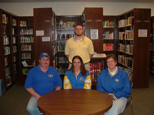 Marion Local senior Abby Schulte, seated center, will continue her education and running career next fall at Ohio Northern University. Seated with Abby are her parents Jerry and Chris Schulte. Marion Local coach Matt Schmackers is in the back row.<br>dailystandard.com