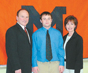 Minster star running back Ty Parks, center, will continue his education and playing career next fall at Mount Union College in Alliance. Standing with Ty is father, and Minster head coach, Whit Parks and mother Beth Parks.<br>dailystandard.com