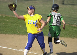 Celina's Allison Hoying, 16, tries to run out a groundball as Marion Local's Kim Evers, 15, catches the ball at first base during the Mercer County matchup on Tuesday night at Bill Feth Diamond. Celina went on to defeat Marion Local, 11-0 in five innings.<br>dailystandard.com