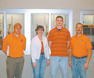 St. Henry lineman Alan Hartke, second from right, will continue his education and playing next fall at the University of Dayton. Posing with Alan are, from left, St. Henry head coach Jeff Starkey, mother Kathy Hartke and father Bill Hartke.<br>dailystandard.com