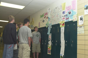 Classmates of Greg Parker and Jonas Kahlig stand near the lockers of the two Celina High School freshman who officials believe drowned in Grand Lake this past weekend. Friends of the 15-year-olds decorated the lockers, located just two lockers apart, in memory of the boys.<br>dailystandard.com