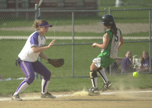 Celina's Julia Siefring, 5, hustles into third base safely as Fort Recovery third baseman Krystal Rammel, left, awaits the ball during their Mercer County showdown on Monday. Fort Recovery defeated Celina for the first time in school history, 1-0.<br>dailystandard.com