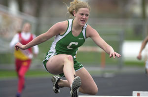 Celina's Lindsey Schmitmeyer clears a hurdle during the 300-meter hurdle event on Tuesday afternoon at Coldwater in a tri-meet also involving New Bremen. Schmitmeyer won the 300 hurdles and helped lead the Lady Bulldogs to the tri-meet win.<br>dailystandard.com