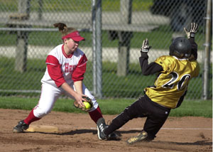 Parkway's Jennifer Murphy, 20, tries to slide into third base but St. Henry's Sarah Osterholt, left, is waiting for her with the ball for the out during Thursday's Midwest Athletic Conference matchup. Parkway defeated St. Henry, 4-1.<br>dailystandard.com