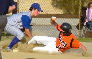 Coldwater's Matt Howell, 10, slides in safely into third base as St. John's Pete Collins tries to lay down the day. Howell had two hits as Coldwater stayed on top the MAC baseball standings.<br>dailystandard.com