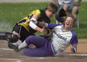 Parkway catcher Jayme Marbaugh, left, blocks the plate and tags out Fort Recovery baserunner Renee Evers, right, during the first inning of Monday's matchup in Mendon. Fort Recovery defeated Parkway, 3-0, to tie the Panthers atop the MAC standings.<br>dailystandard.com