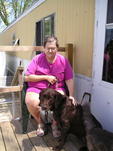 Susan Bobenmoyer Stump and her pilot dog, Alley, get some sun on her Celina front porch. Both woman and dog received training to work together to help Stump get around.<br>dailystandard.com