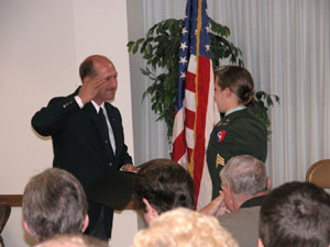 Pat Hemmelgarn, former post commander of the American Legion, St. Henry, returns a salute from his daughter, Sgt. Noel Zimmerman of the Ohio National Guard, during a special ceremony Sunday morning. Legion officials in St. Henry, as well as those across the country, honored military men and women and their families in an Armed Forces celebration this past weekend.<br>dailystandard.com