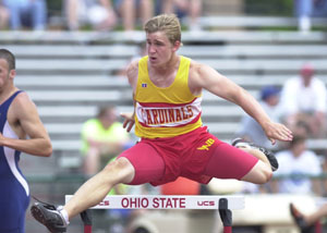 New Bremen's Troy Lammers clears the hurdle during the 300-meter hurdles at the state track meet on Saturday in Columbus. Lammers defended his state championship in the 300-meter hurdles by winning the event again on Saturday in a time of 38.15.<br>dailystandard.com
