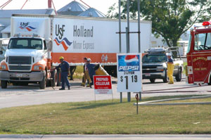 Local officials assist a Dayton-area hazardous materials crew as they stabilize and clean up a chemical that leaked from a semitrailer behind the Shell gasoline station in Coldwater on Monday afternoon. The flammable chemical, similar to airplane glue, was noticed leaking from the semitrailer about 1:30 p.m. Local officials were on the scene for more than eight hours. No injuries were reported.<br>dailystandard.com