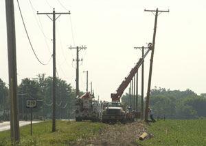 Work crews move back electric poles along state Route 219 east of Montezuma in preparation for a road-widening project. State Route 219 will be widened from the Franklin school building to Behm's Road. Ohio Department of Transportation is in charge of the project and also plans to construct a bike path along the road.<br>dailystandard.com