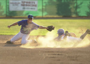 Grand Lake's Dusty Hammond, left, tries to tag out a Lima baserunner during their game on Thursday at Jim Hoess Field. The Mariners defeated rival Lima, 10-7.<br>dailystandard.com