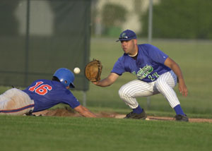 Grand Lake first baseman Michael Ayala waits for the throw as Lima's Jay Morrow, 16, slides back in during Tuesday's GLSCL game at Jim Hoess Field.<br>dailystandard.com