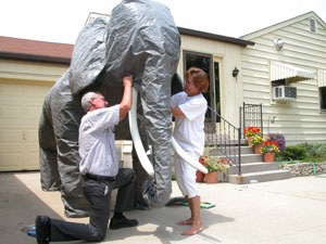 Don't fret, Ted Stachler and wife, Ellen, aren't being overcome by a stampeding elephant. The Celina couple are putting the finishing touches on the large beast they created to help advertise the upcoming vacation Bible school at St. John Lutheran Church in Celina. The work being done in their Enterprise Street driveway has caused plenty of double takes by passers-by.<br>dailystandard.com