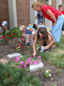 Camp Inquire teacher Shannon Pence helps her students look for insects during this week's session of 