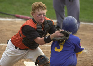 Coldwater catcher Cody Muhlenkamp, left, tags out St. Marys baserunner Doug Burke, 3, as he tries to score during the district ACME tournament at St. Henry's Wally Post Athletic Complex on Tuesday night. Coldwater advanced to the winner's bracket final with a 7-2 win over St. Marys.<br>dailystandard.com