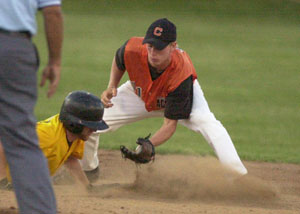 Coldwater's Cory Klenke, in orange, puts the tag on Fairview's Toby Hill, in yellow,  during their state ACME tournament game at Veterans Field on Wednesday. Coldwater won the game 10-0 to advance to the final, to be played on Saturday.<br>dailystandard.com