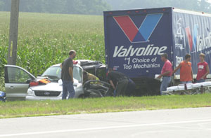 A Celina firefighter works inside a damaged minivan trying to free the driver following a two-vehicle accident Monday afternoon west of Celina. Dorothy Ann Schaefer, 66, 3630 state Route 118, Coldwater, was pronounced dead on arrival at the hospital.<br>dailystandard.com