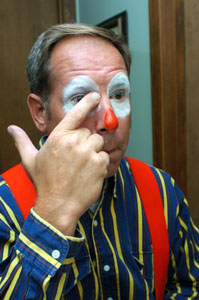 Terry Humphries, president of St. Marys Veterans of Foreign Wars Post 9289 Clown Unit, applies makeup for an appearance. The unit, organized in 1971, was once the only known VFW organization of its kind in the world. Members voted in June to disband. Their final appearance is at Saturday's St. Marys Summerfest Parade.<br>dailystandard.com