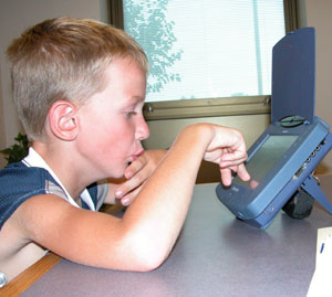 Jacob Siefring, who was born with a disease that left him unable to talk, demonstrates how he uses a Dynavox communication device to answer questions from his teachers. He is being honored today in Columbus with the R.A. Horn Award for his outstanding achievement.<br>dailystandard.com