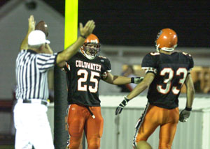 Coldwater's Ross Homan, 25, celebrates a touchdown with teammate Joe Wermert, 33, as the referee signals the score. Homan and the Cavaliers didn't have much trouble against Kenton as the Cavaliers defeated the Wildcats, 40-6.<br>dailystandard.com
