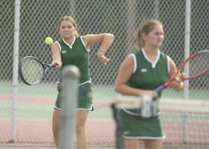 Brittni Gunter, left, returns a serve while partner Jess VanTilburg waits for the return. Gunter and VanTilburg won their first doubles match in two sets.<br>dailystandard.com