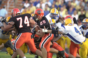 Coldwater's Ross Homan, 25, fights for extra yardage as teammate Paul Matthewson, 74, makes a block downfield on Friday night against Marion Local. Homan ran 138 yards and had a touchdown in the Cavaliers' 38-7 win over the Flyers.<br>dailystandard.com