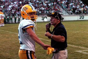 St. Marys head coach Doug Frye, right, talks with Roughriders quarterback Brett Baker during last week's game against Celina. Frye and the rest of the Roughriders play their first home game this week hosting Defiance.<br>dailystandard.com