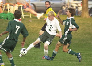 Celina's Kyle White, 12, maneuvers his way through the Greenville defense during their soccer match on Saturday night in Celina. White had the lone score of the game in a 1-0 Bulldogs victory.<br>dailystandard.com