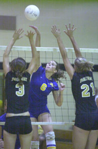 Marion Local's Stephanie Brunswick, 6, spikes the ball between Parkway's Laura Art, 3, and Tiffany Steinbrunner, 21, during their match on Thursday. Marion Local won the match in three games.<br>dailystandard.com