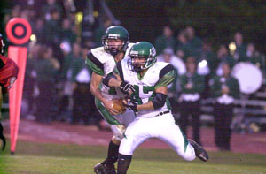 Celina's Erik Chapin was a standout for the Bulldogs on both sides of the ball on Friday night against Lima Shawnee in Western Buckeye League action. Chapin, 10, fakes the handoff to running back Brandon Ley, 47, and looks for a pass downfield. Chapin had over 100 yards rushing and passingwith three touchdowns in helping the Bulldogs to a 29-28 victory over Shawnee.<br>dailystandard.com