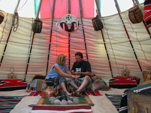 Donna and George Kinnison work on Native American crafts inside their 23-foot high tepee along Elm Street in Coldwater. The couple, who are both part Native American, take the tepee to several rendezvous events each year and join others dressed in authentic clothing of Native Americans and mountain men and women.<br></br>dailystandard.com