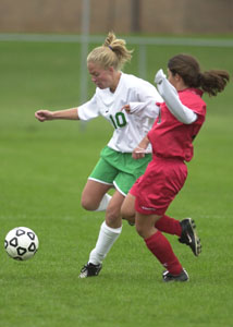 Celina's Liz Klosterman, 10, dribbles past a Toledo Central Catholic defender during their match on Saturday. Klosterman scored to help the Bulldogs to a 4-0 victory.<br></br>dailystandard.com