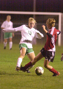 Celina's Rachel Schollmeier, left, tries to kick the ball away from a Wapakoneta player during Tuesday's WBL match at Celina. The Bulldogs won their final home match of the season 5-0.<br></br>dailystandard.com