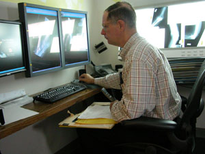 Radiologist Dr. John Cox reviews an X-ray image that was digitalized by the Picture Archival and Communication System (PACS) at Mercer County Community Hospital, Coldwater. The hospital began using the new equipment Oct. 3 and it will be one of the items showcased during the annual Fall Health Fair this Saturday at the facility.<br></br>dailystandard.com