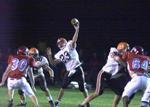 Versailles' Tony McNeilan, 23, throws the ball deep downfield during the Tigers' opening-round playoff game against Lima Central Catholic at Lima Stadium on Friday night. LCC defeated Versailles, 21-20.<br></br>dailystandard.com
