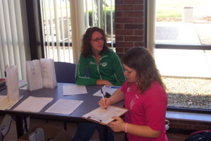 Student Joanna Osterloh signs a petition for no smoking zones near the front entrances and picnic areas at the Lake Campus. If passed, smokers would have to go behind the buildings.<br></br>dailystandard.com