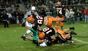 Coldwater's Gaston Pleiman, 82, and teammate Tyler Kunk, 18, bring down a Clear Fork ball carrier during their game on Saturday night. The Cavalier defense pitched a shutout in a 45-0 blowout win.<br></br>dailystandard.com