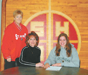 St. Henry volleyball standout Kayla Lefeld, seated right, will play college volleyball next season at Cleveland State University. Seated with Kayla is her mother Cindy. St. Henry volleyball coach Lori Schwieterman is in the back.<br></br>dailystandard.com