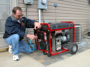 Joe Weaver demonstrates how his portable generator works in the backyard of his home in St. Marys. Weaver, the assistant fire chief for the city of St. Marys, purchased the equipment during the ice storm in January when he was out of power for several days.<br></br>dailystandard.com