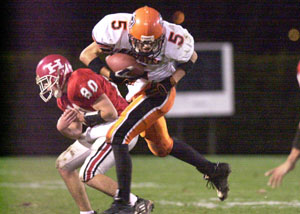 Coldwater's Ryan Geier, 5, steps in front of Huron's Bradley Dominy, 80, for an interception during their Division IV playoff game on Saturday night at Findlay's Donnell Stadium. Coldwater advanced to the state semifinals with a 28-0 win over Huron.<br></br>dailystandard.com