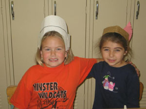 Pilgrim Carly Barhorst and American Indian Natalie Oakley, both first-graders at Minster Elementary School, put their heads together. <br></br>dailystandard.com